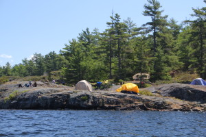 Campers on a rock - out canoeing